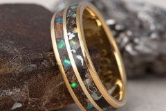 yellow gold wedding ring with dinosaur bone, meteorite and opal inlay