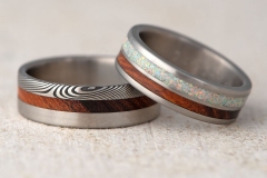 handcrafted wedding rings made from titanium, damascus steel, desert ironwood and white opal