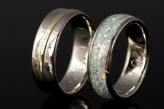 handmade pair of wedding rings made from white and yellow gold and white opal inlay on womens ring